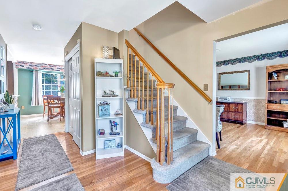 5 Netty Street Howell, NJ 07731 - Photo 6 of 36 a view of a hallway with wooden floor and staircase