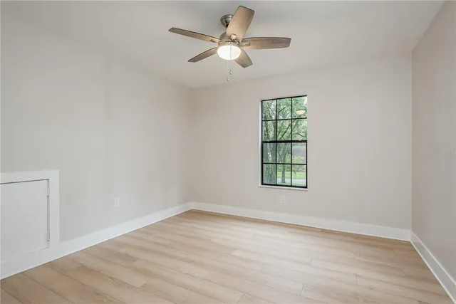 wooden floor in an empty room with a window
