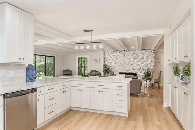 a kitchen with a lot of counter space and wooden floors