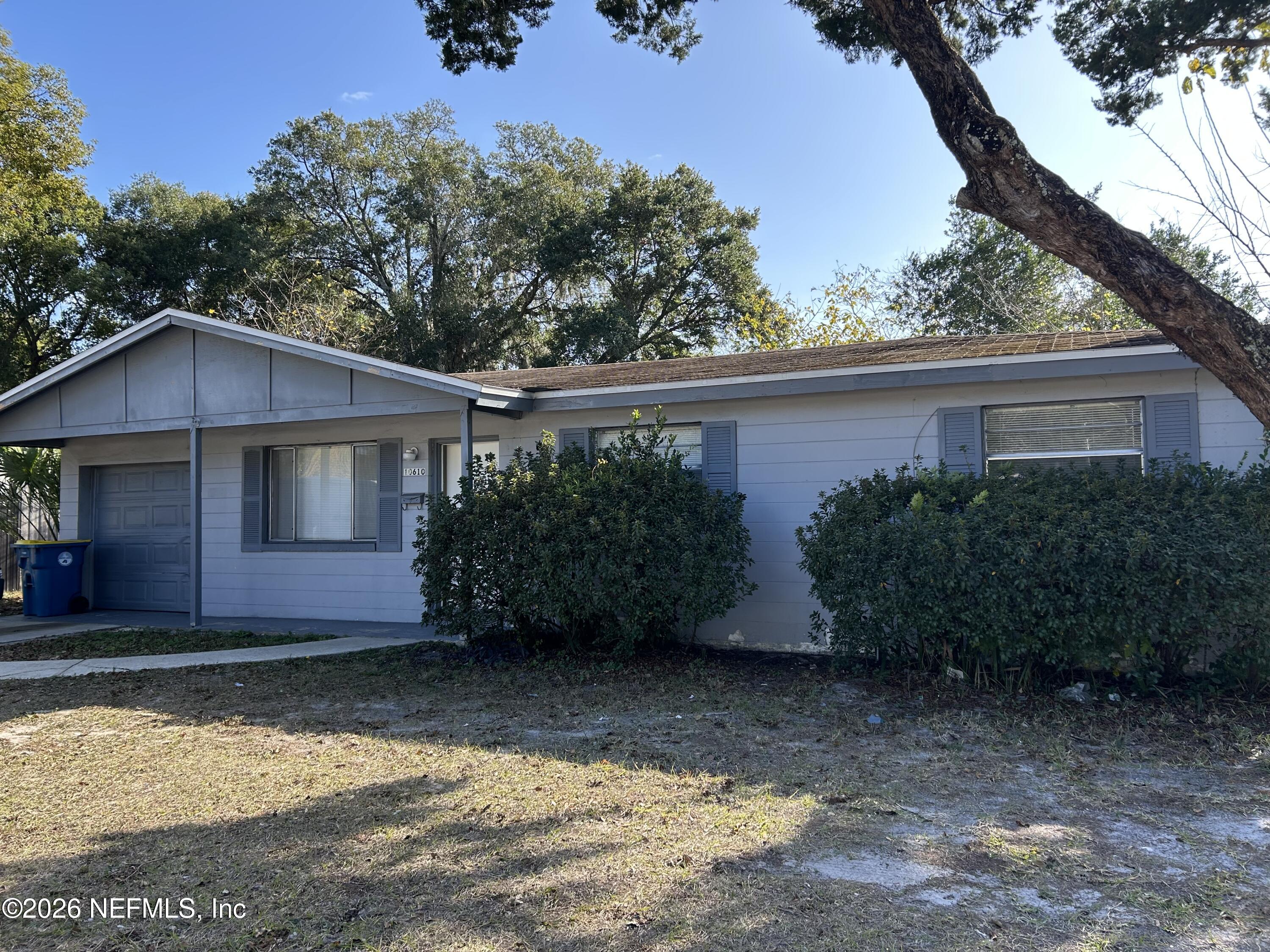 10610 Lone Star Road Jacksonville, FL 32225 - Photo 1 of 18 a house that has a tree in front of it