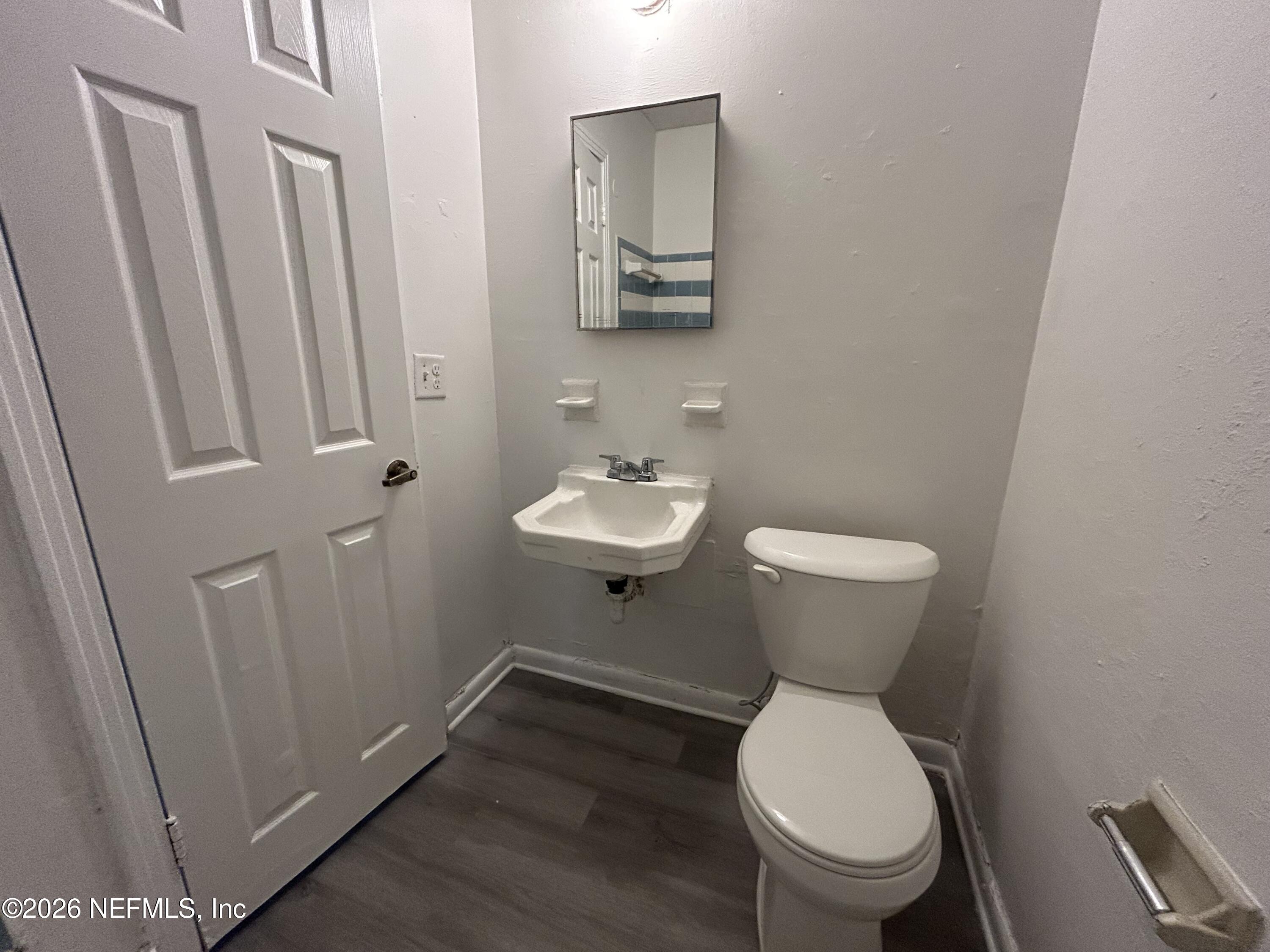 10610 Lone Star Road Jacksonville, FL 32225 - Photo 13 of 18 a bathroom with a toilet sink and mirror