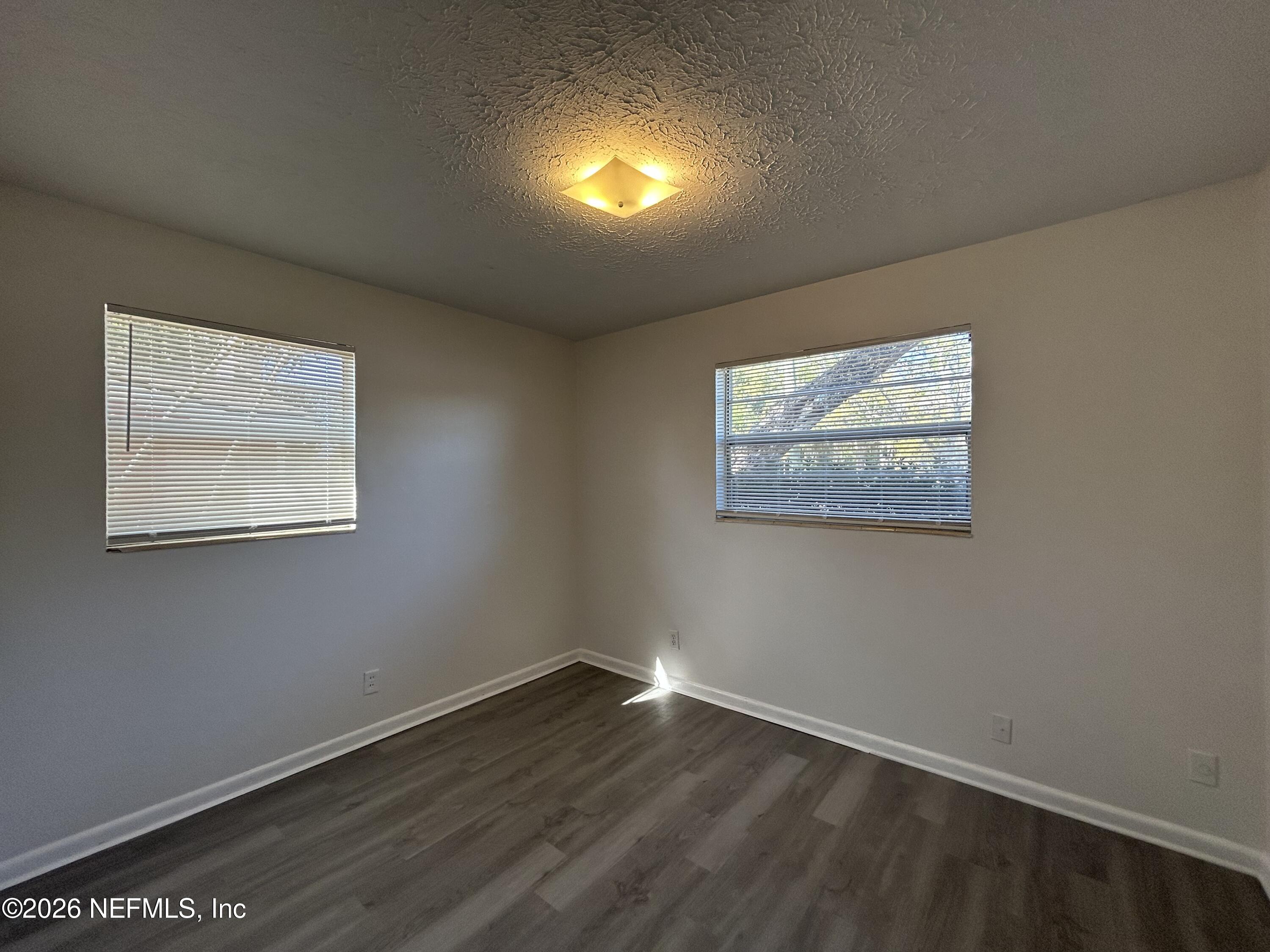 10610 Lone Star Road Jacksonville, FL 32225 - Photo 14 of 18 wooden floor in an empty room