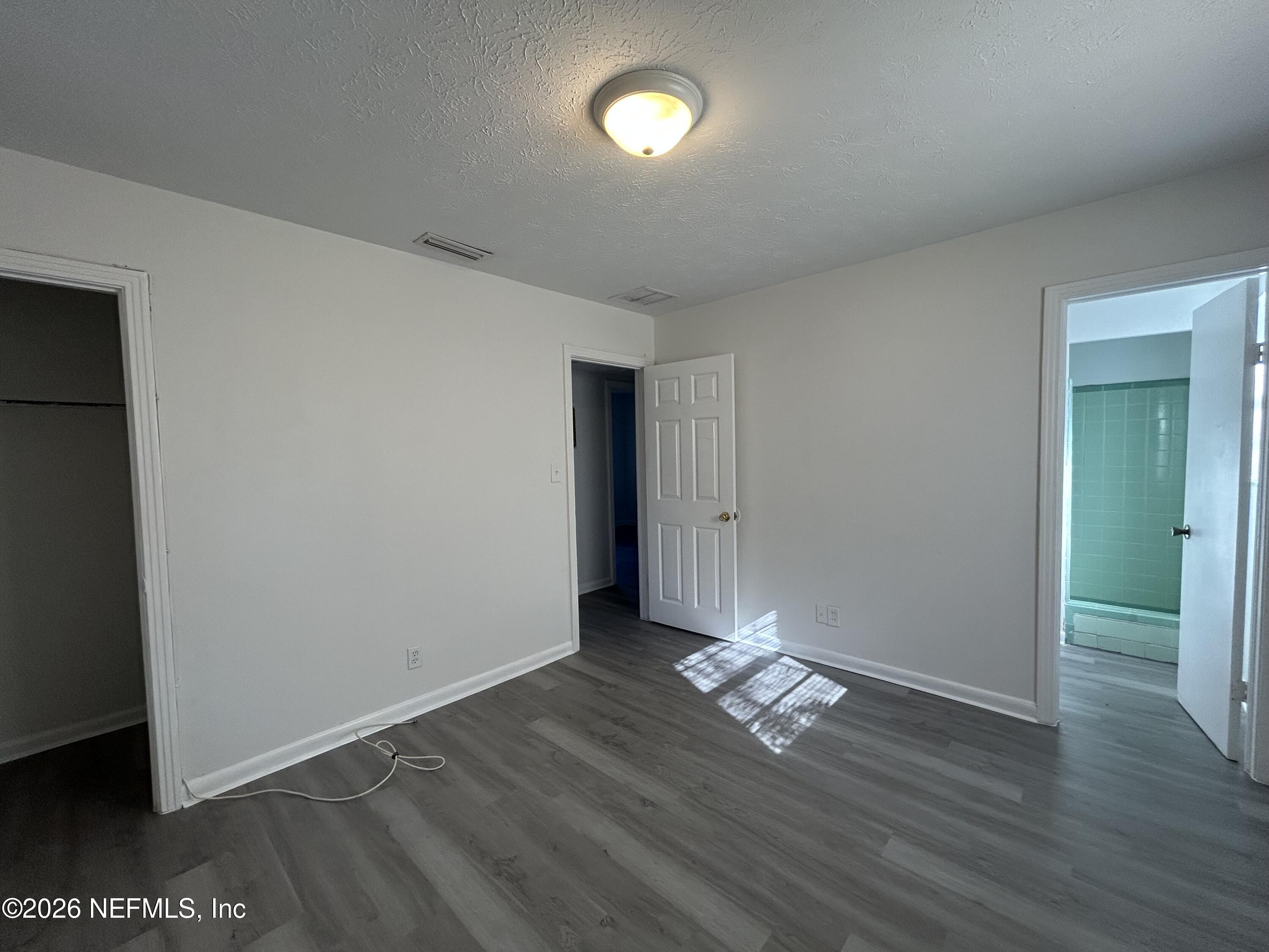 10610 Lone Star Road Jacksonville, FL 32225 - Photo 15 of 18 a view of empty room with wooden floor