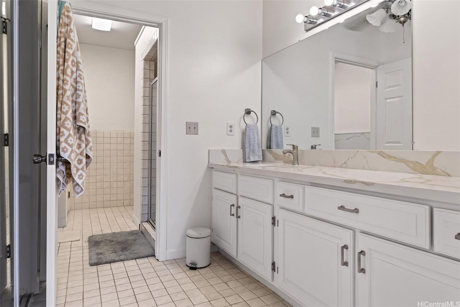 5207 Poola Street Honolulu, HI 96821 - Photo 12 of 25 a bathroom with a double vanity sink toilet and shower