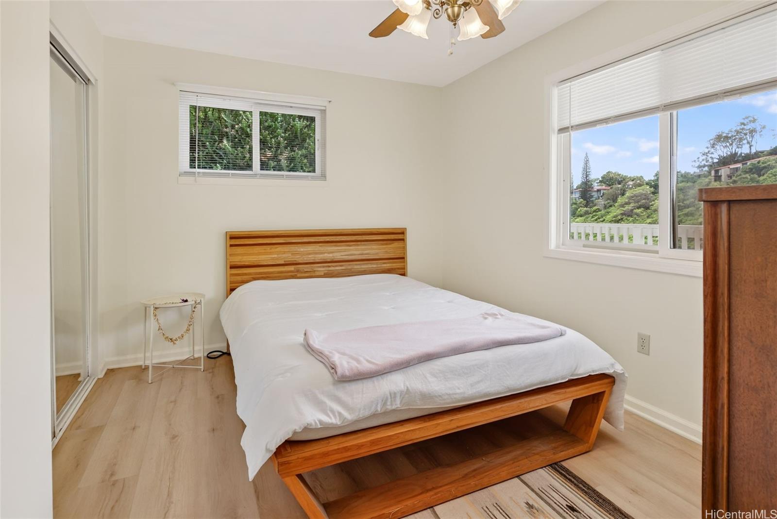 5207 Poola Street Honolulu, HI 96821 - Photo 15 of 25 a bedroom with a bed and wooden floor