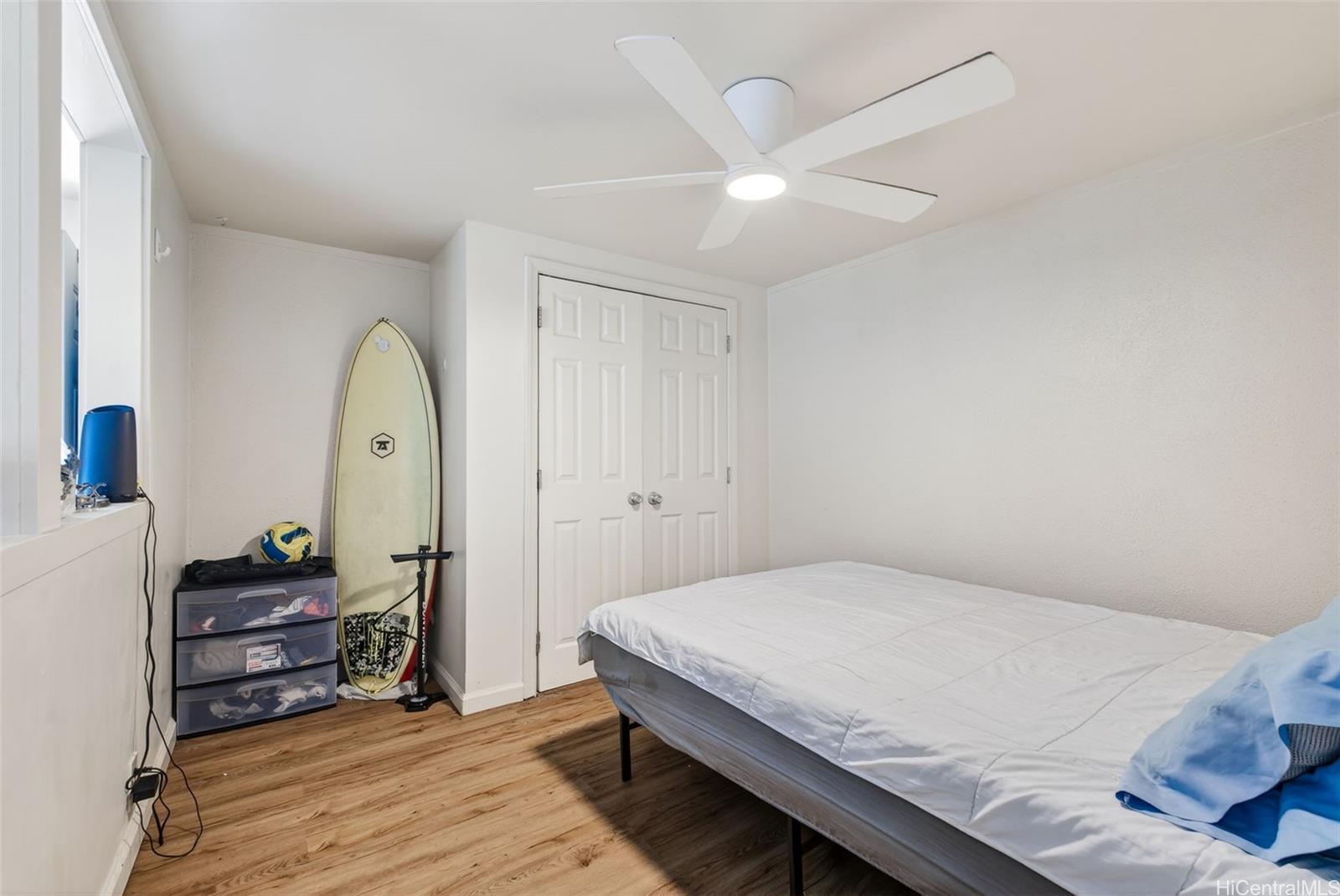 5207 Poola Street Honolulu, HI 96821 - Photo 21 of 25 a bedroom with a bed and a chandelier