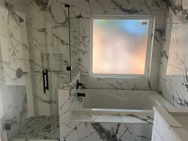 a bathroom with a bathtub and shower