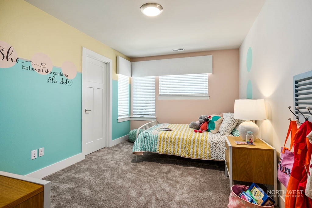 21509 6th Drive Southeast, Unit RM11 Bothell, WA 98021 - Photo 18 of 26 a bedroom with a bed and a window