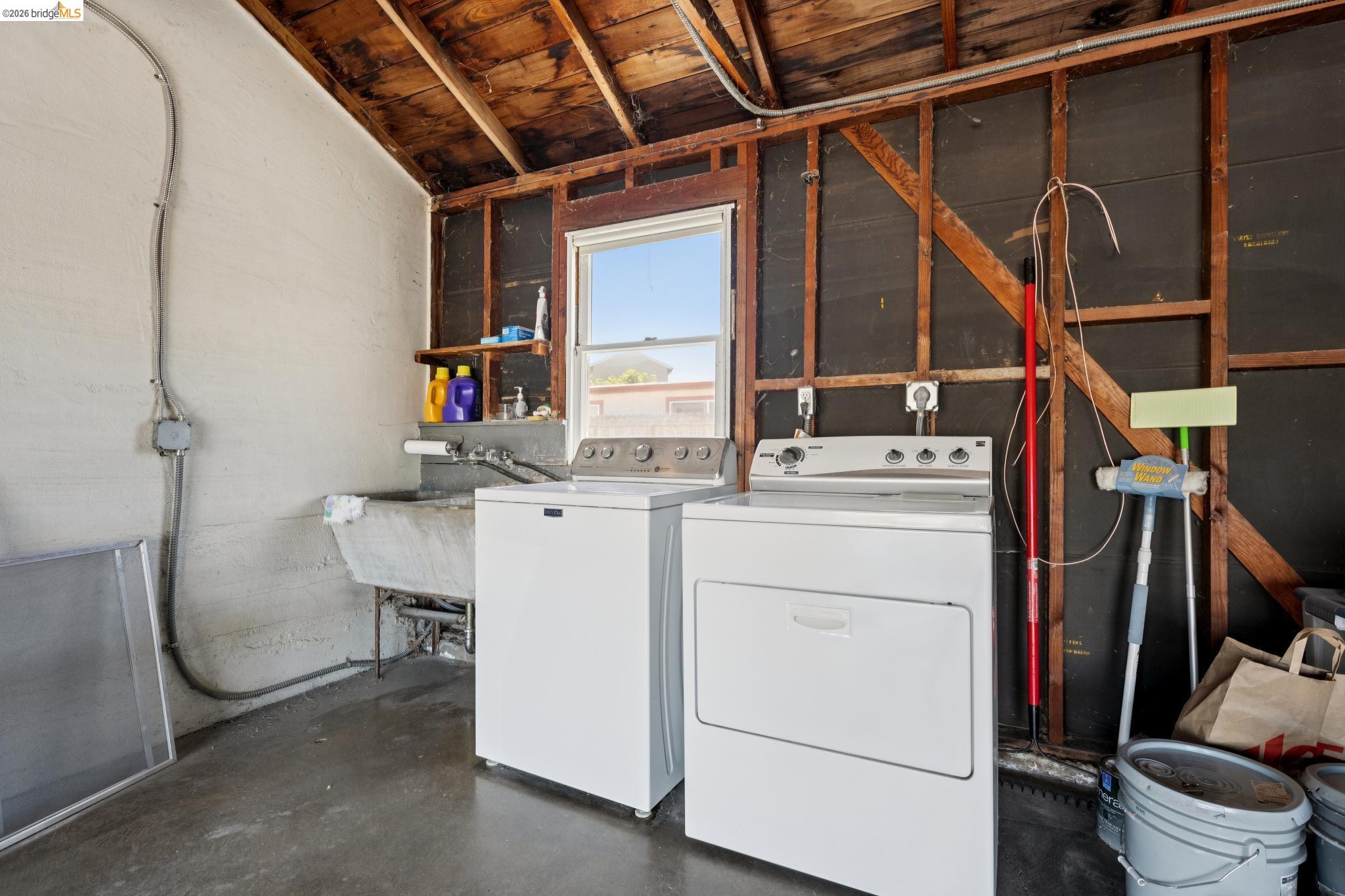 15162 Inverness Street San Leandro, CA 94579 - Photo 25 of 25 Dedicated laundry area featuring a utility sink, a window, and exposed wood ceiling joists