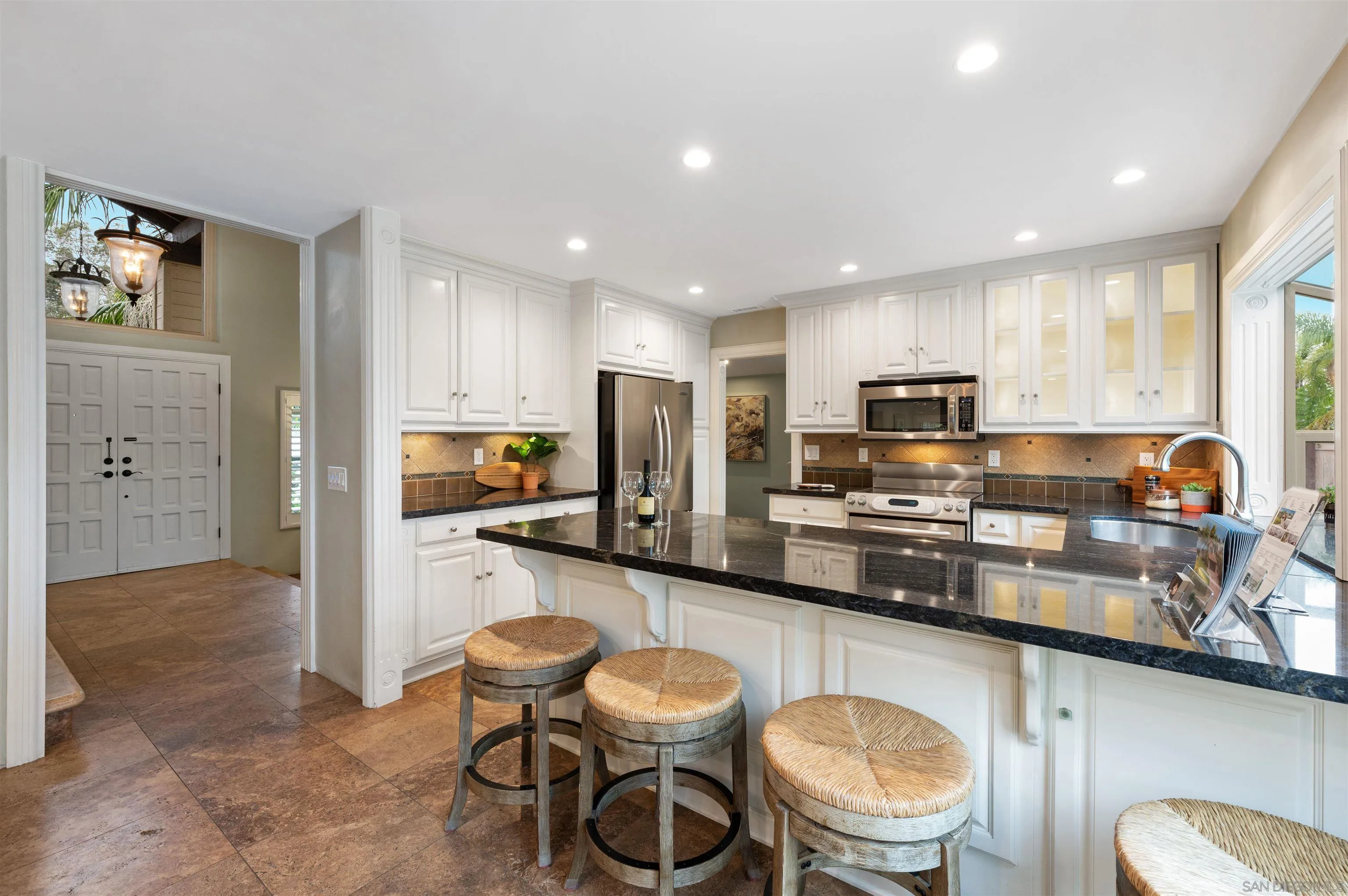 2312 Marca Place Carlsbad, CA 92009 - Photo 12 of 56 a kitchen with stainless steel appliances kitchen island granite countertop a sink and cabinets