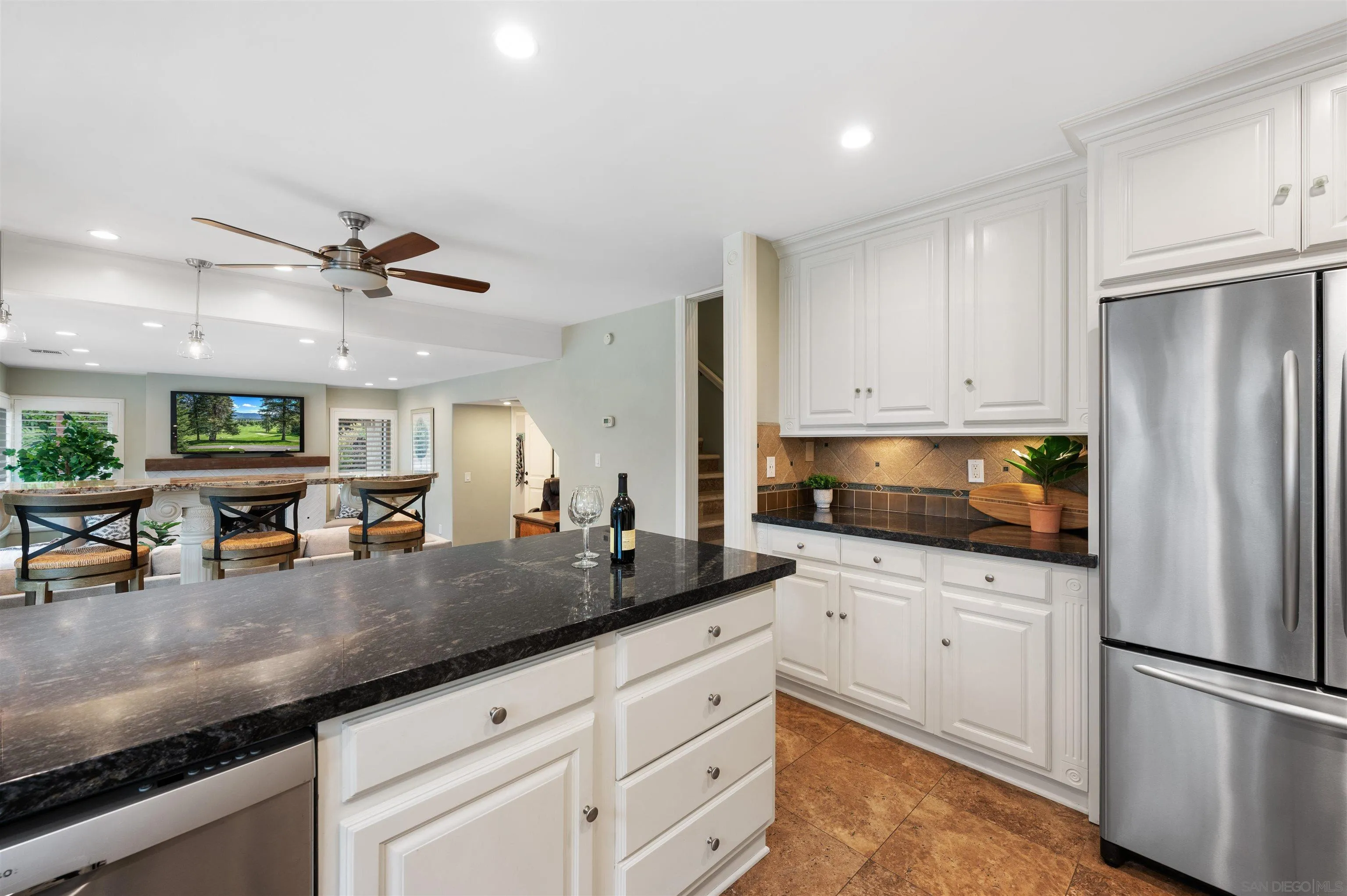 2312 Marca Place Carlsbad, CA 92009 - Photo 14 of 56 a kitchen with stainless steel appliances granite countertop a sink a stove and a refrigerator