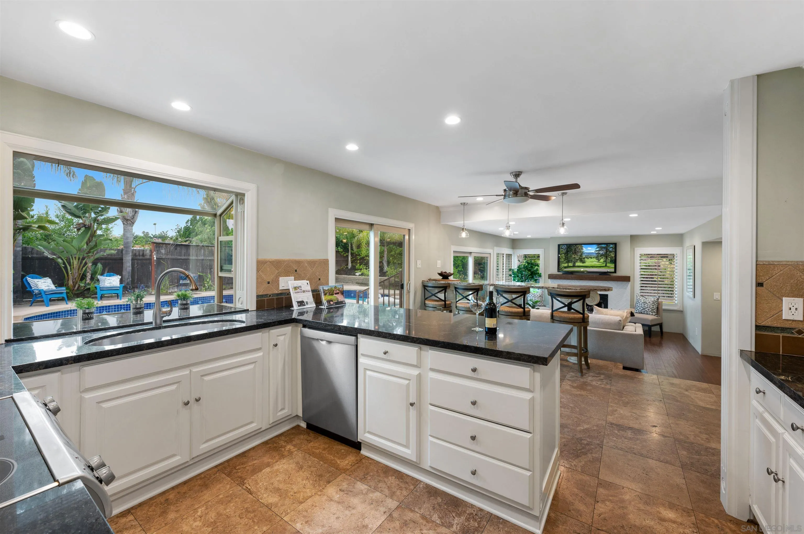 2312 Marca Place Carlsbad, CA 92009 - Photo 15 of 56 a kitchen with lots of counter top space and living room
