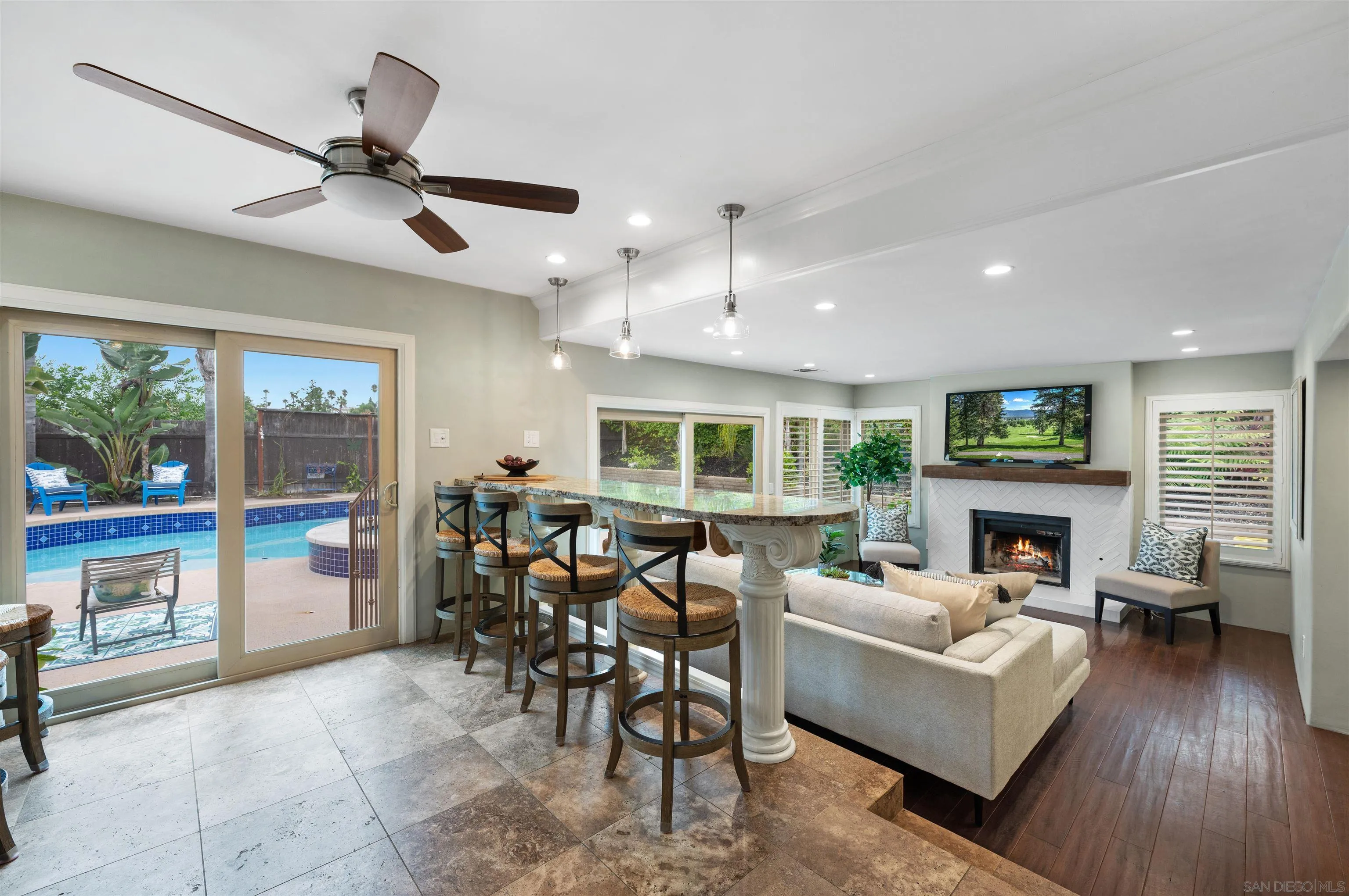 2312 Marca Place Carlsbad, CA 92009 - Photo 17 of 56 a living room with furniture a fireplace and a floor to ceiling window