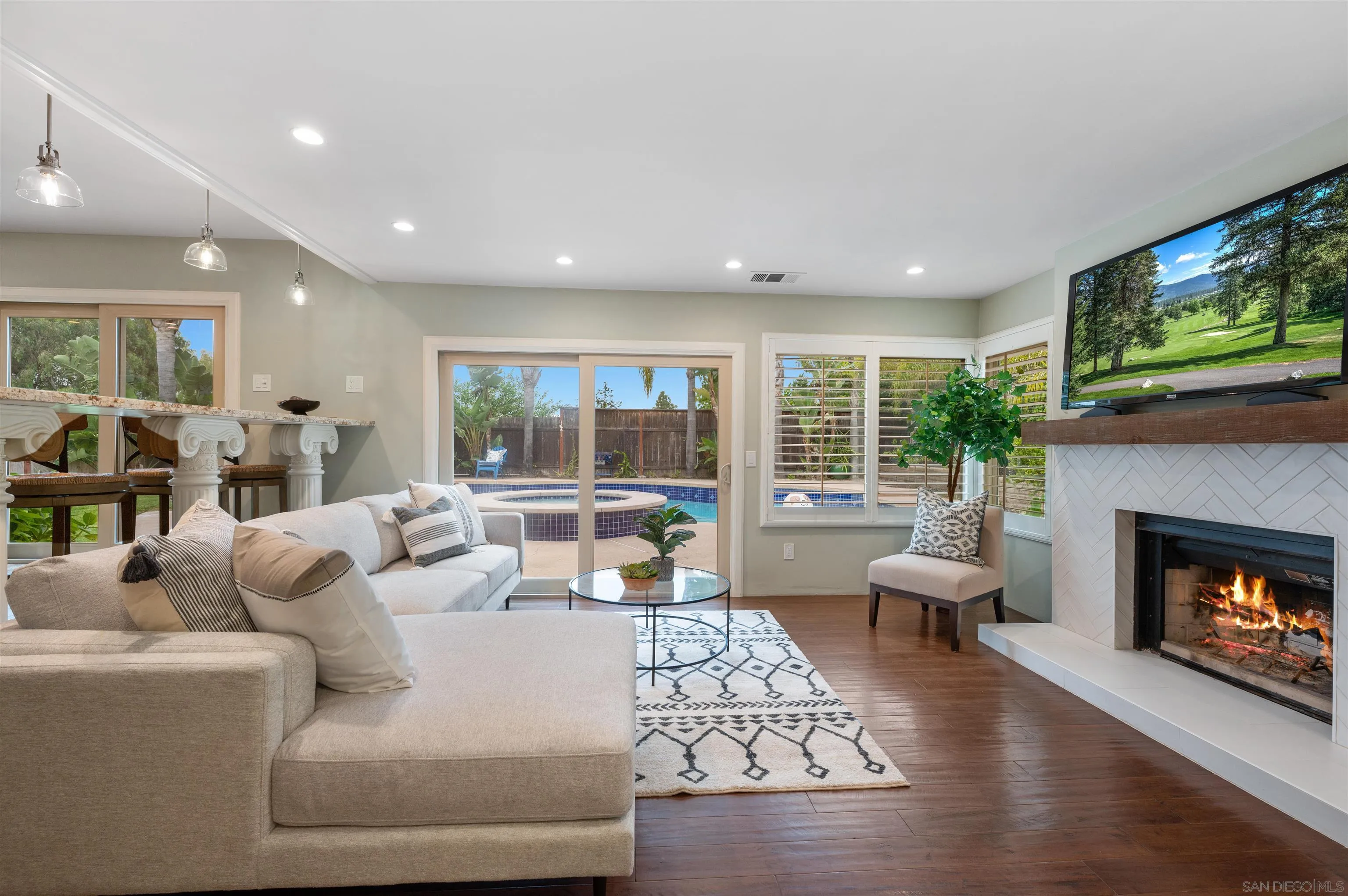 2312 Marca Place Carlsbad, CA 92009 - Photo 18 of 56 a living room with furniture a fireplace and a flat screen tv