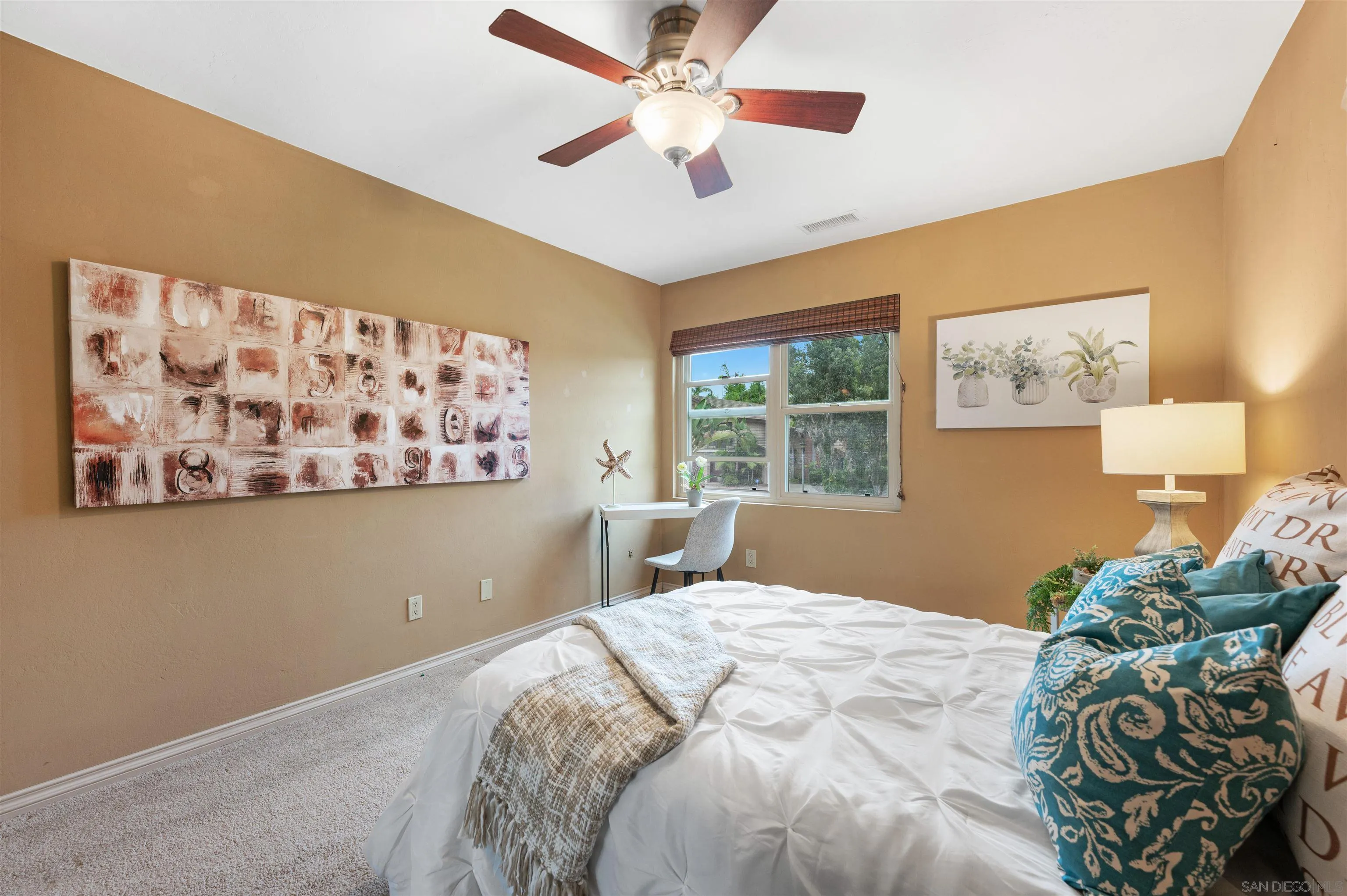 2312 Marca Place Carlsbad, CA 92009 - Photo 25 of 56 a bedroom with a bed and a window with a bookshelf