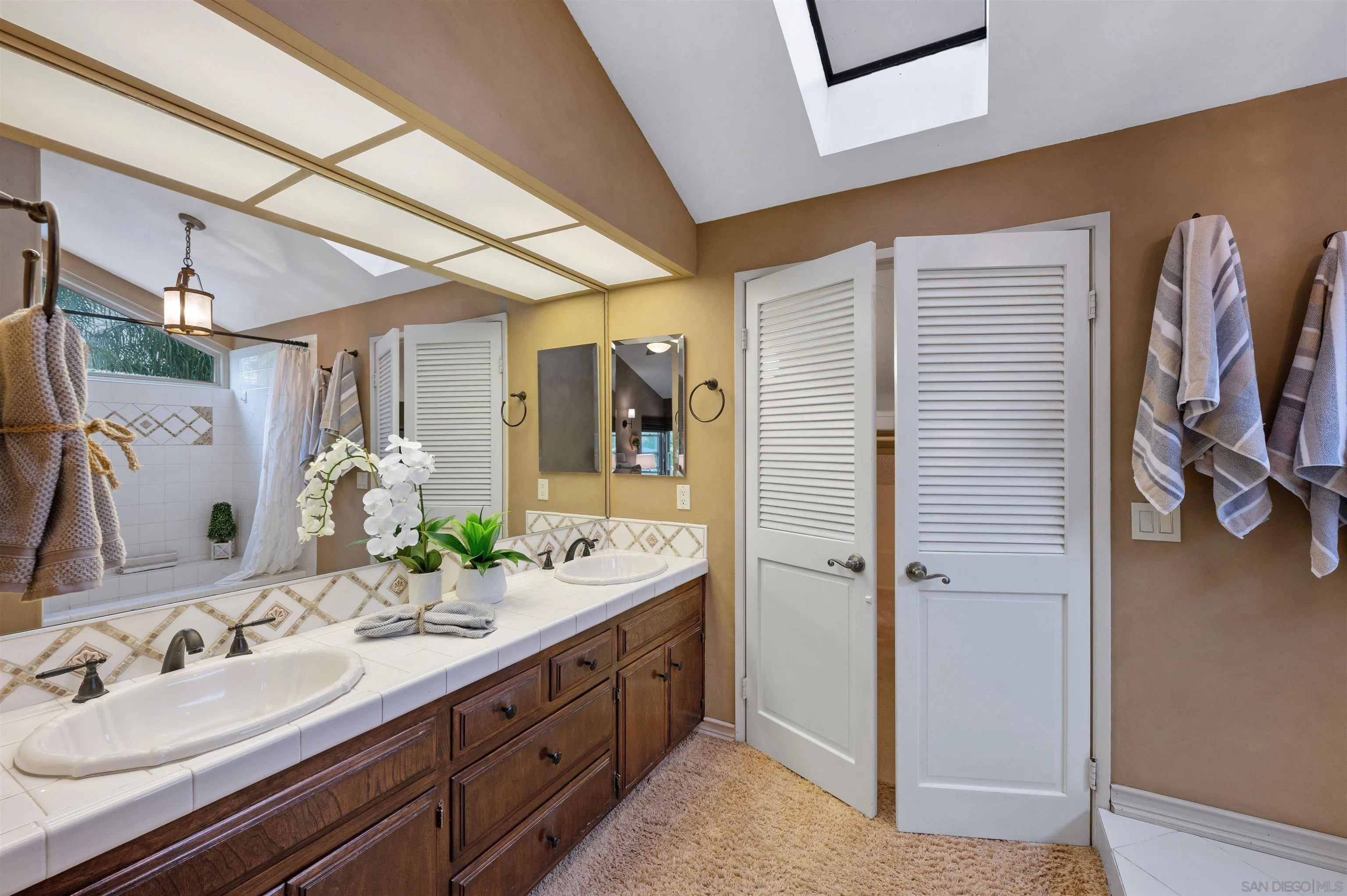 2312 Marca Place Carlsbad, CA 92009 - Photo 32 of 56 a bathroom with a double vanity sink and mirror