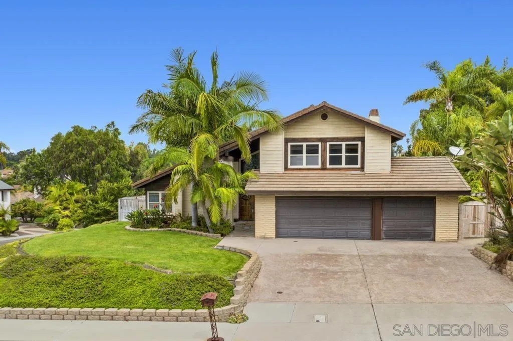 2312 Marca Place Carlsbad, CA 92009 - Photo 44 of 56 a front view of a house with a yard and garage