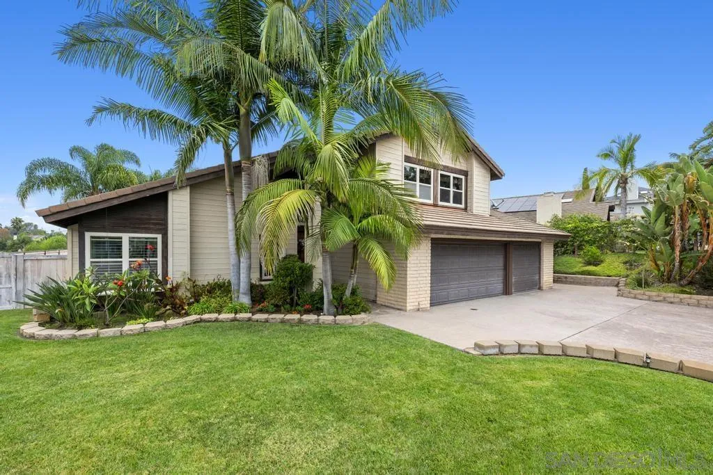 2312 Marca Place Carlsbad, CA 92009 - Photo 45 of 56 a front view of a house with a garden and yard