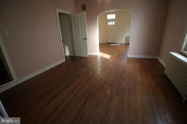 a view of a room with wooden floor and a window