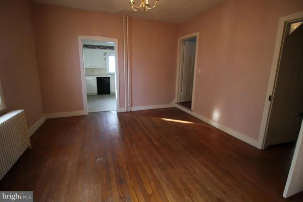 a view of a room with wooden floor and a sink