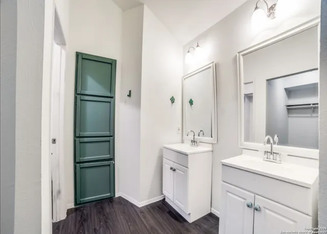 a bathroom with a double vanity sink mirror and