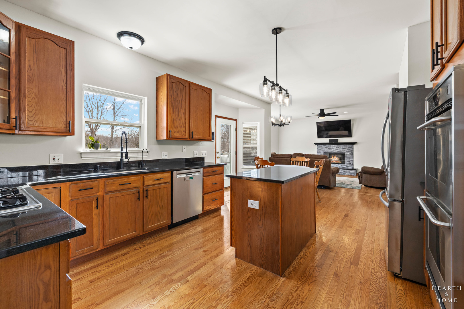 10514 Ridge Lane Marengo, IL 60152 - Photo 11 of 51 a large kitchen with stainless steel appliances granite countertop wooden cabinets a refrigerator a stove a sink and dishwasher with wooden floor