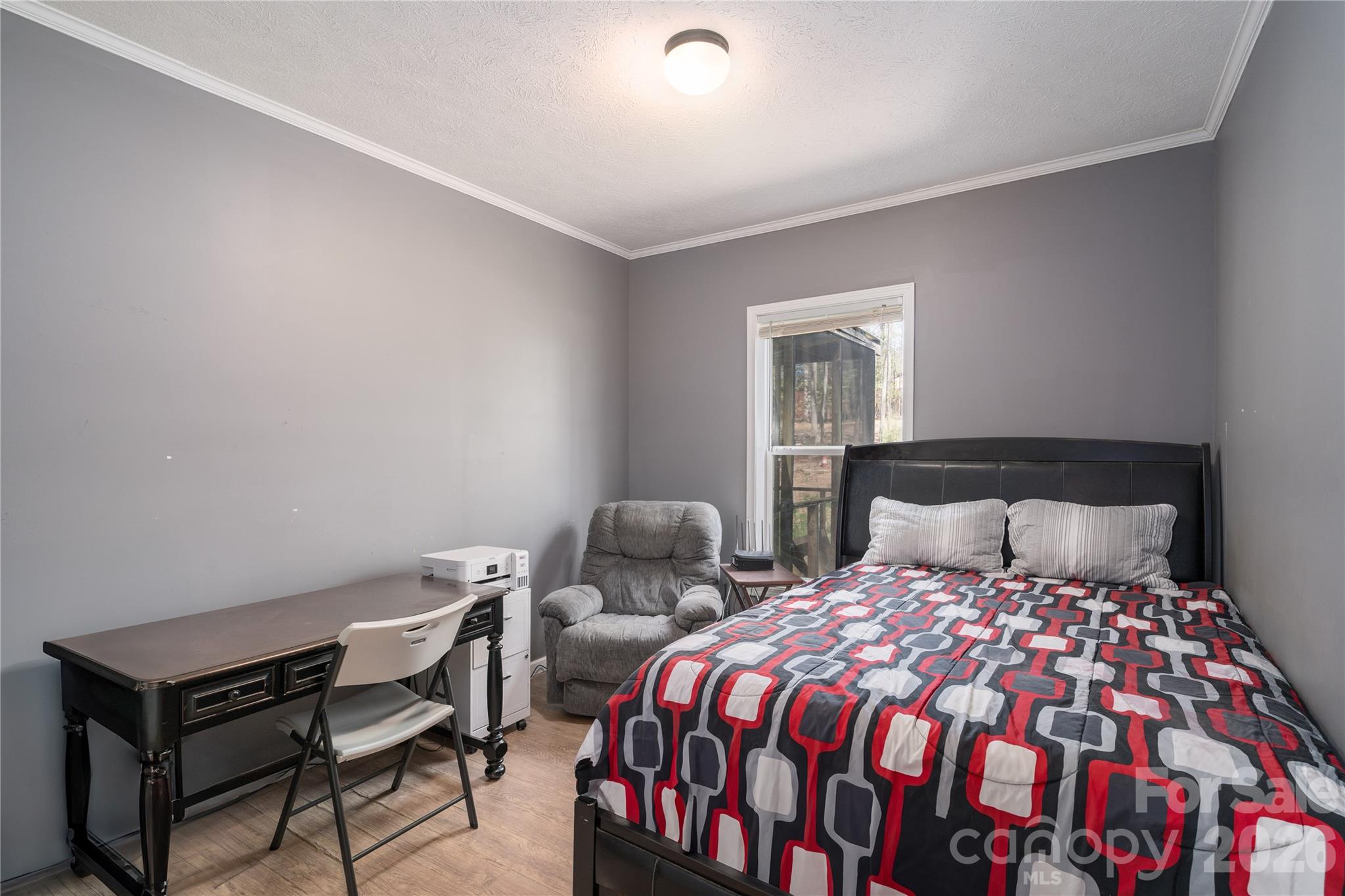296 Stillwater Road Troutman, NC 28166 - Photo 21 of 33 a bedroom with a bed and a lamp on table