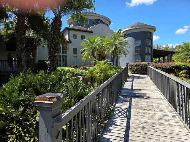 a view of a house with wooden floor and potted plants