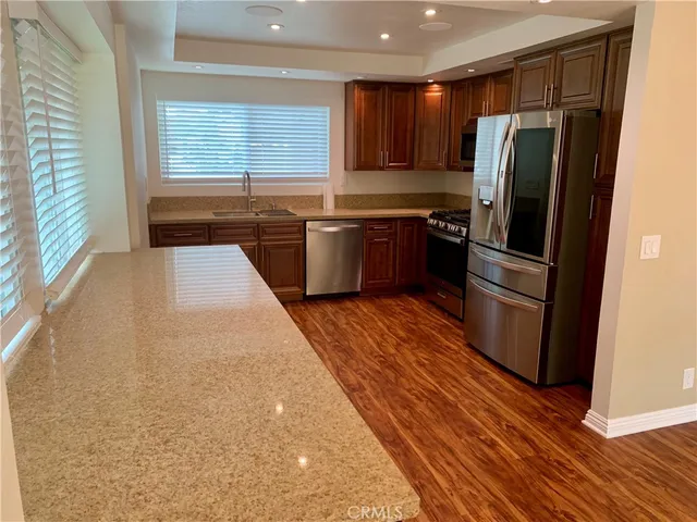 a kitchen with stainless steel appliances a refrigerator and a sink