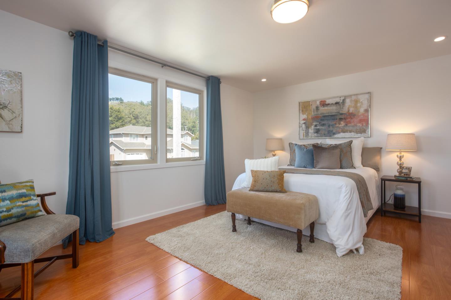 932 Crespi Drive Pacifica, CA 94044 - Photo 18 of 26 a bedroom with a bed and chair