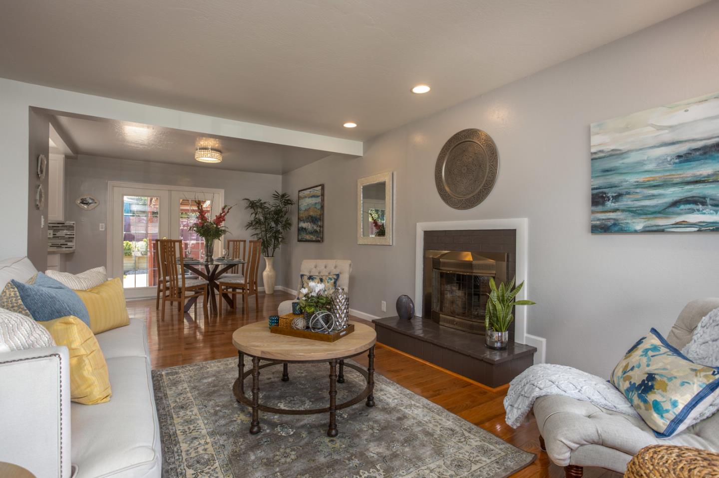 932 Crespi Drive Pacifica, CA 94044 - Photo 2 of 26 a living room with furniture a fireplace a rug and a window