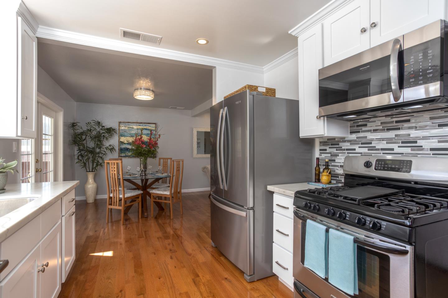 932 Crespi Drive Pacifica, CA 94044 - Photo 10 of 26 a kitchen with stainless steel appliances a stove a sink and a refrigerator