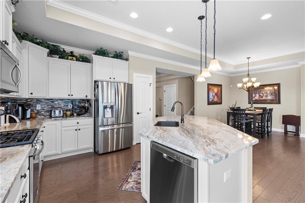 225 Brookside Drive Cranberry Township, PA 16066 - Photo 9 of 34 a kitchen with refrigerator cabinets and wooden floor