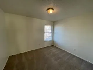 an empty room with a empty space and a window