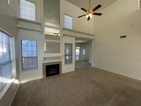 a view of a livingroom with a fireplace and fan