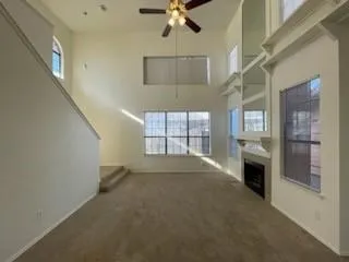 a view of an empty room with a fireplace and a window
