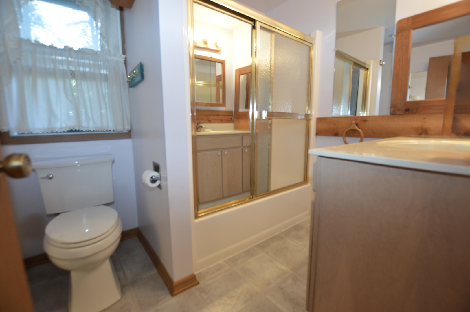 10905 Breezy Lawn Road Spring Grove, IL 60081 - Photo 18 of 20 a bathroom with a granite countertop sink mirror vanity and toilet