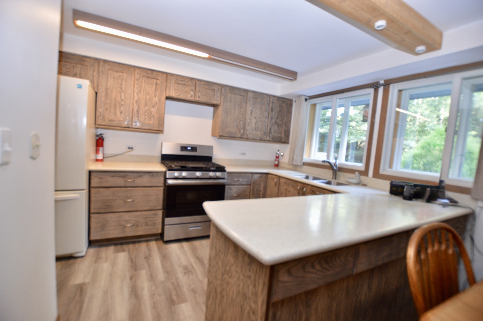 10905 Breezy Lawn Road Spring Grove, IL 60081 - Photo 5 of 20 a kitchen with a stove a sink and a refrigerator