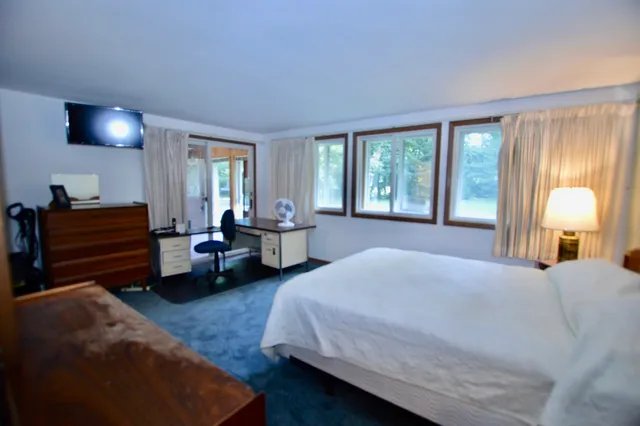 a spacious bedroom with a bed and a couch