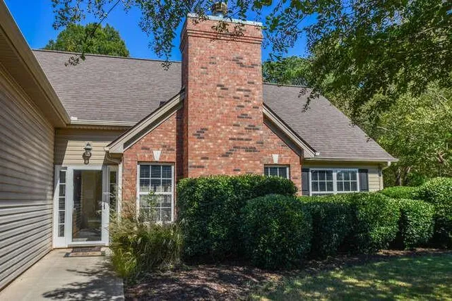 a living room with furniture fireplace and a window