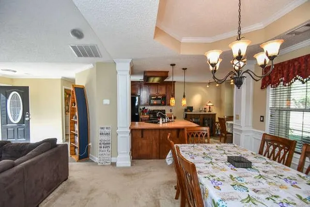 a living room with furniture a window and a flat screen tv