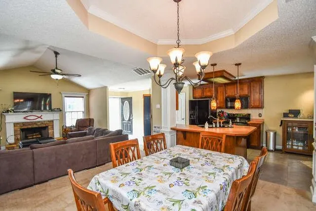 a bedroom with a large bed and chandelier