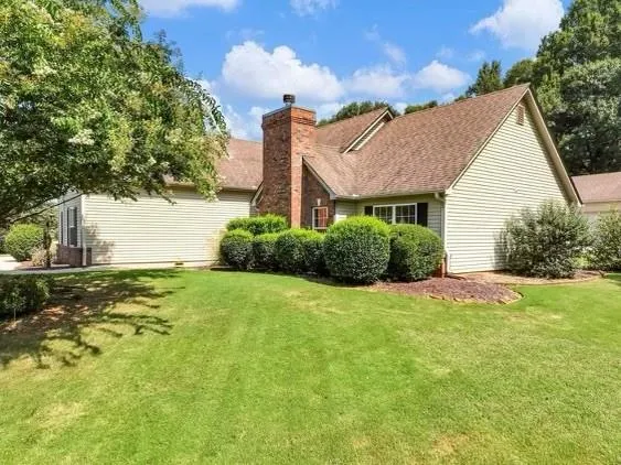 a view of a house with a yard and garage