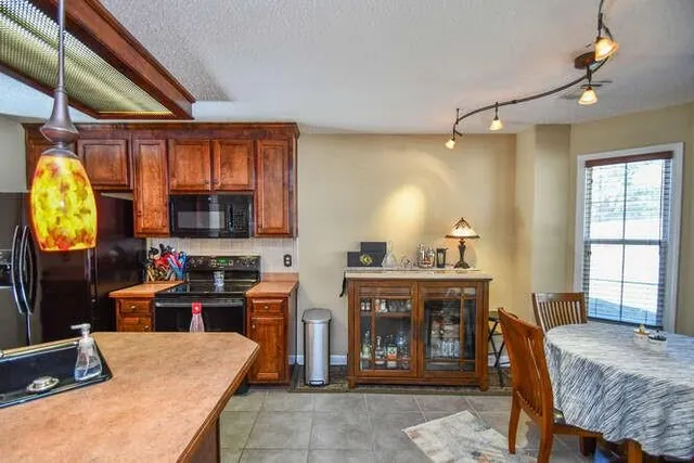 a en suite bathroom with a granite countertop sink and a mirror