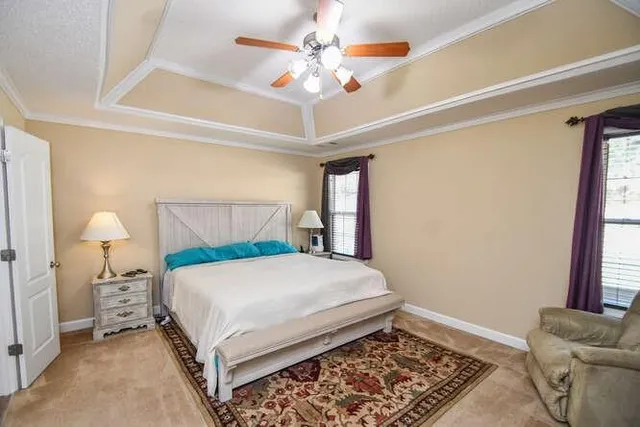 a bedroom with furniture and a chandelier