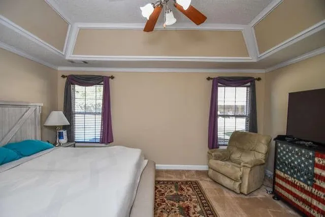 a bedroom with furniture and a tv