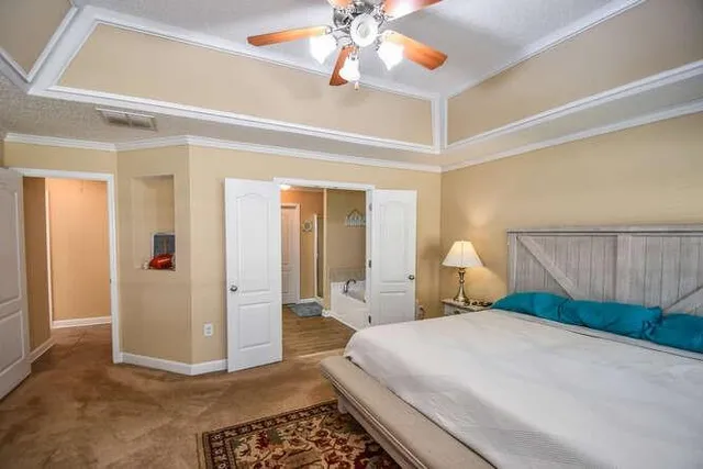 a bedroom with a bed and a chandelier