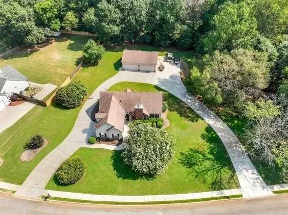 a view of a house with backyard and a garage