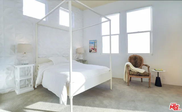 a spacious bedroom with a bed and furniture