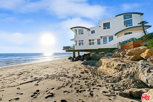 a view of a bedroom with a bed and furniture